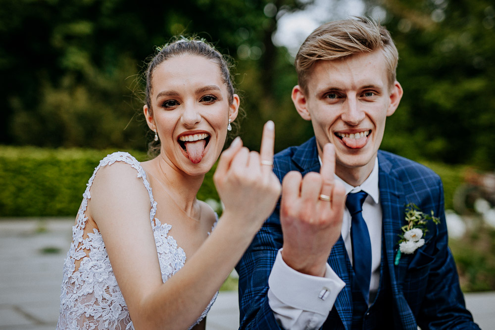 para młoda pokazuje obrączki podczas sesji ślubnej na poznańskiej cytadeli